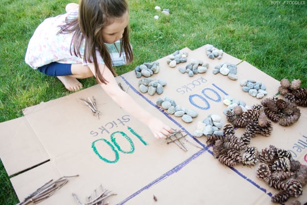 Kids learning about 100 with an outdoor math activity