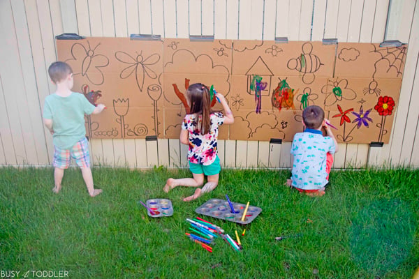 Kids having fun at a giant activity painting outside