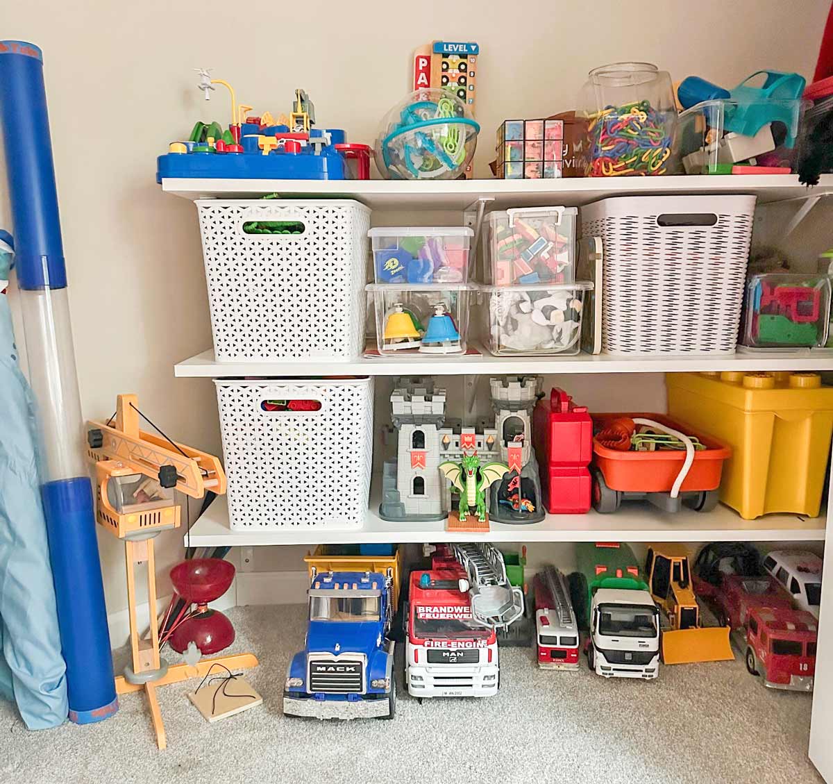 Image shows a child's closet full of organized toys in bins and clear boxes.