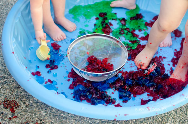 Toddlers having a fun time with Jello in a kiddie pool.