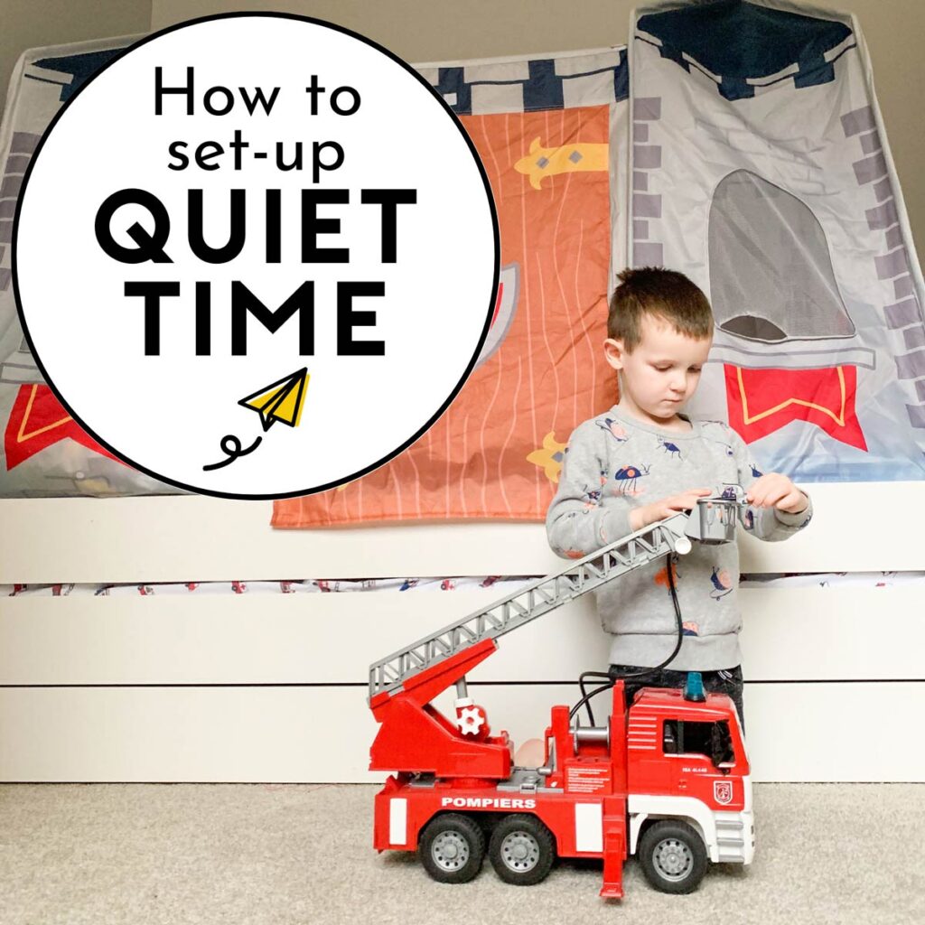 How to set-up quiet time: a child sits on the floor of his room in front of his bed. He is playing with a large fire truck.