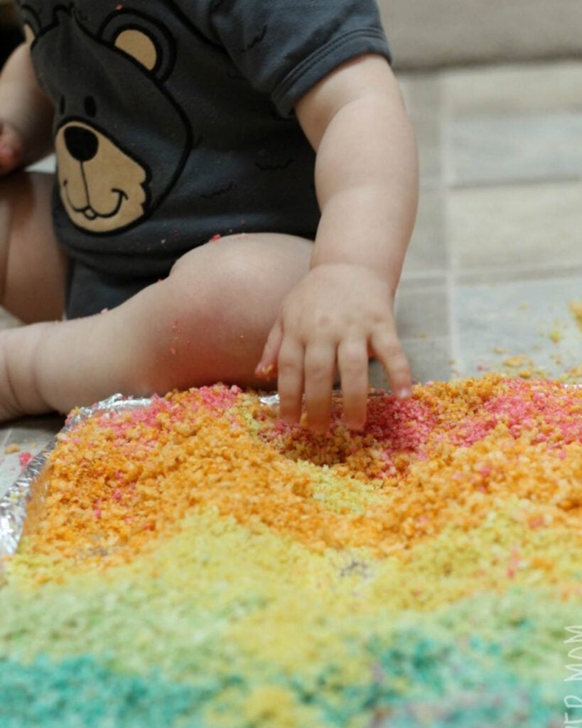 A child plays with dyed bread.