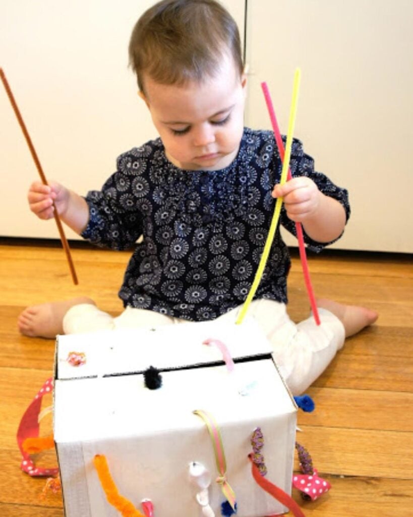 A child plays with a tugging box.