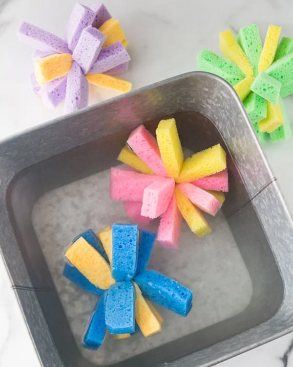 Cut up sponges are ties together to make sun burst shapes.