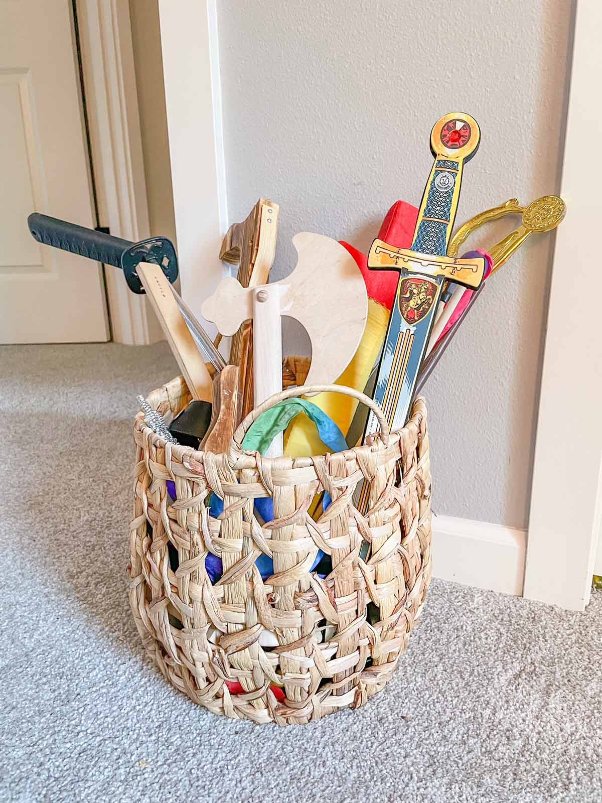 A woven basket full of toy weapons for kids