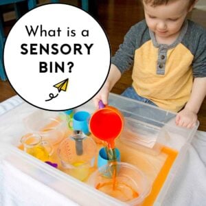 A child pouring orange water into a storage container. Text reads: What is a sensory bin?